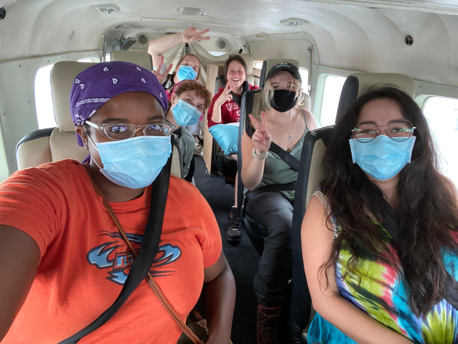 The All Hands and Hearts team wearing face masks on a bus.