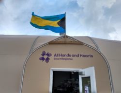 All Hands and Hearts work tent with flag of the Commonwealth of the Bahamas. 