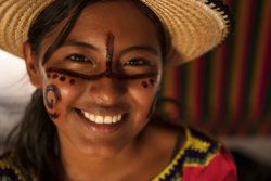 An indigenous young woman with traditional Wayuu face paint.